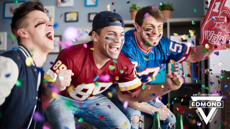 Three football fans cheering during a game-day watch party as colorful confetti falls around them.